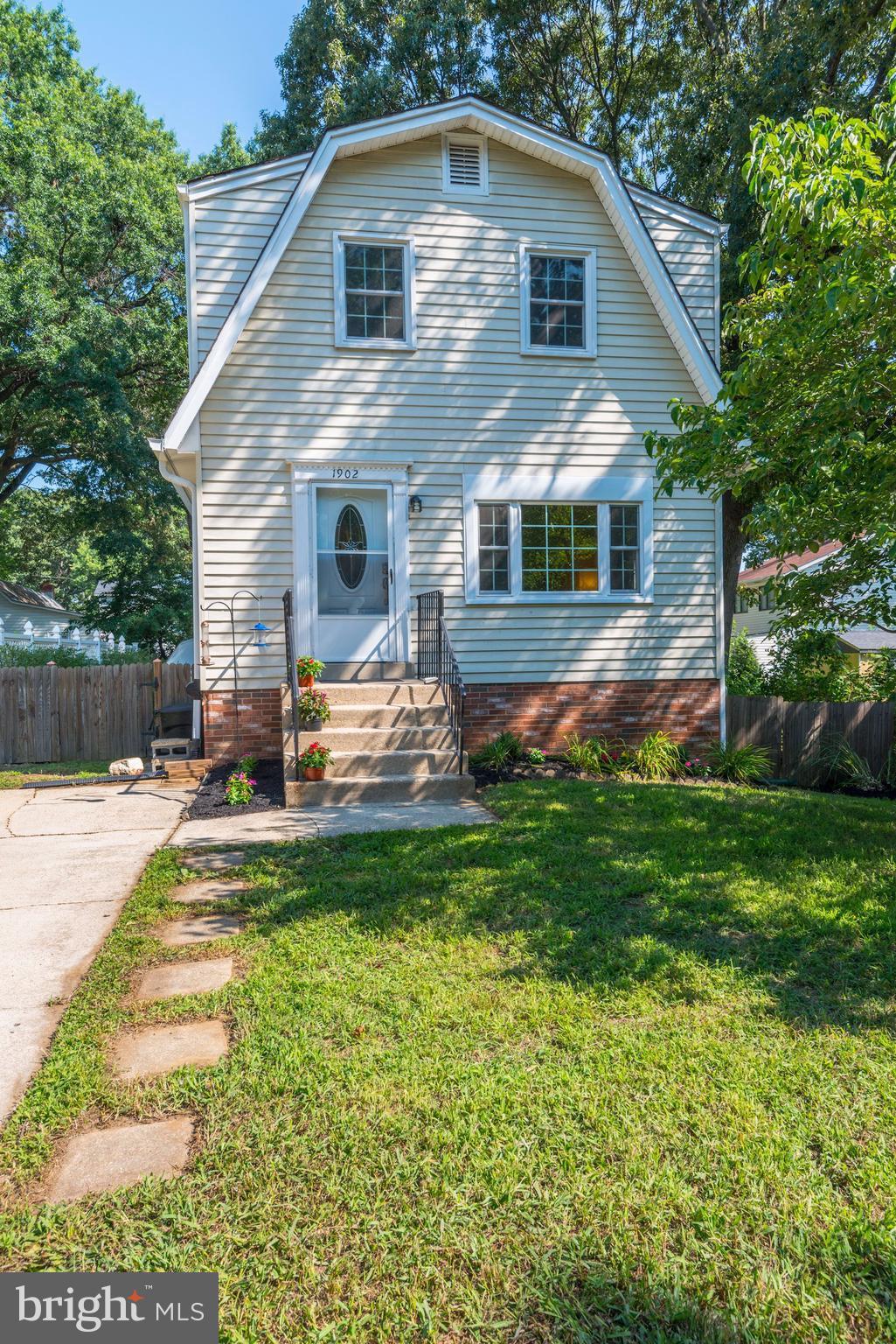 a front view of a house with a yard table and chairs