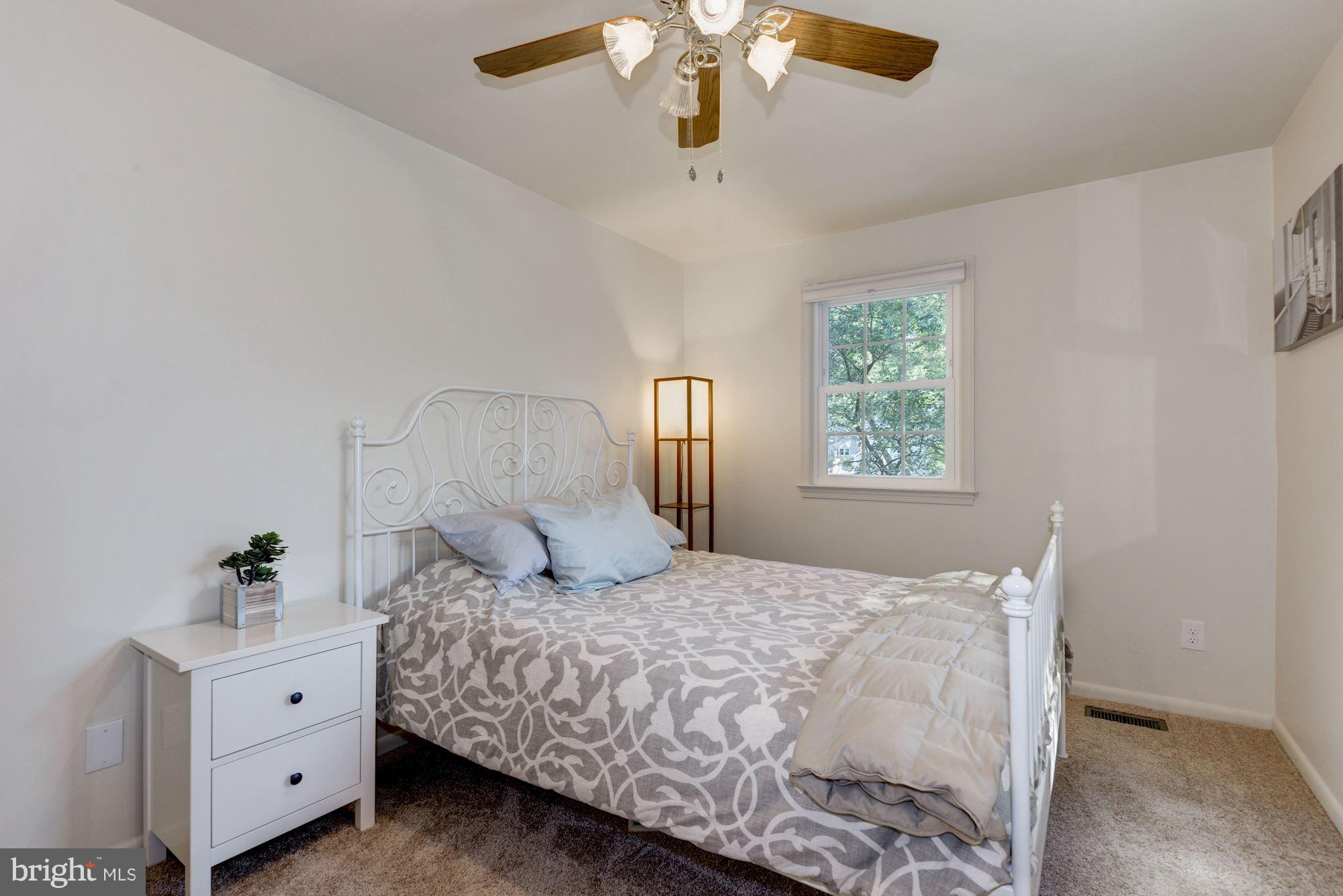 1902 Potomac Road Edgewater, MD 21037 - Photo 14 of 29 a bedroom with a bed and a chandelier