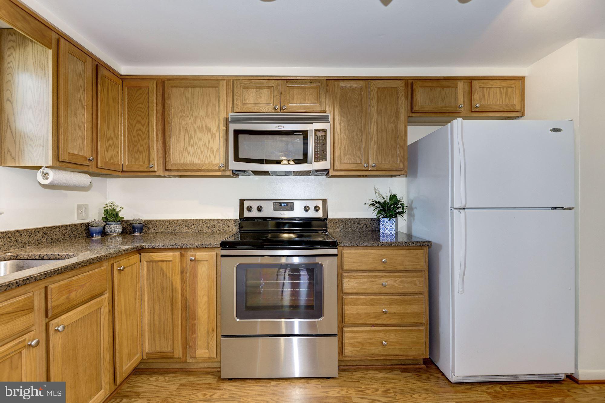 1902 Potomac Road Edgewater, MD 21037 - Photo 7 of 29 a kitchen with stainless steel appliances granite countertop a stove a microwave and a refrigerator