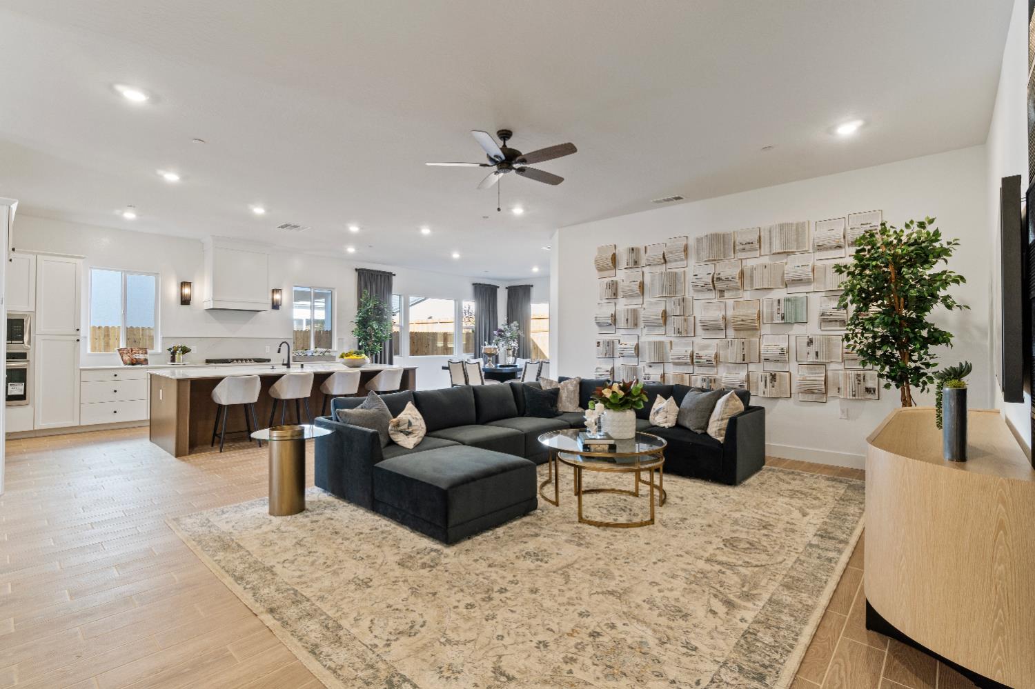 846 Traverse Drive Madera, CA 93636 - Photo 11 of 28 a living room with fireplace furniture and a potted plant