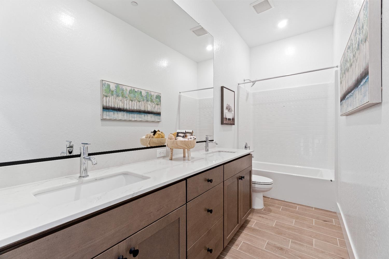 846 Traverse Drive Madera, CA 93636 - Photo 22 of 28 a bathroom with a double vanity sink and a mirror