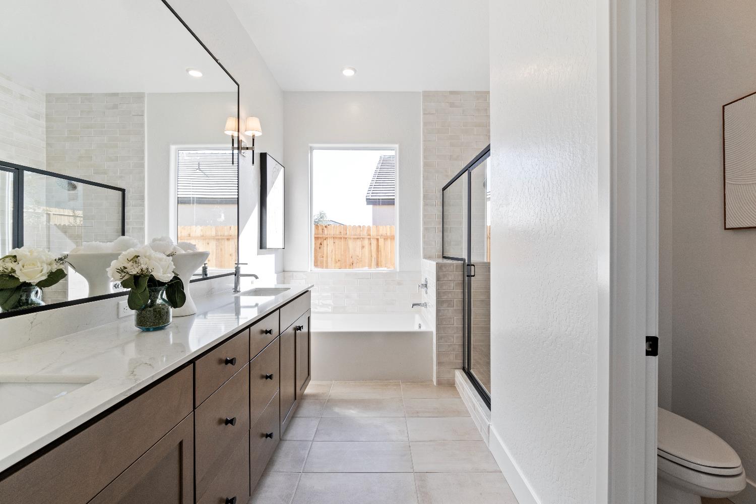 846 Traverse Drive Madera, CA 93636 - Photo 27 of 28 a bathroom with a granite countertop sink mirror and a bathtub