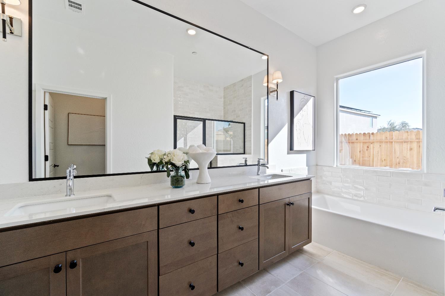 846 Traverse Drive Madera, CA 93636 - Photo 28 of 28 a bathroom with a double vanity sink and mirror with window