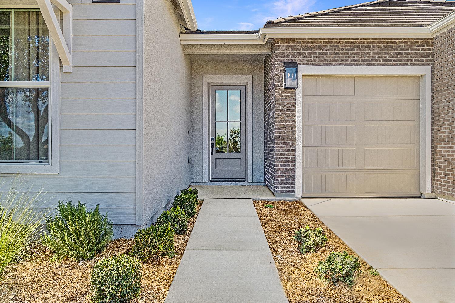 846 Traverse Drive Madera, CA 93636 - Photo 4 of 28 front view of a brick house with a small yard