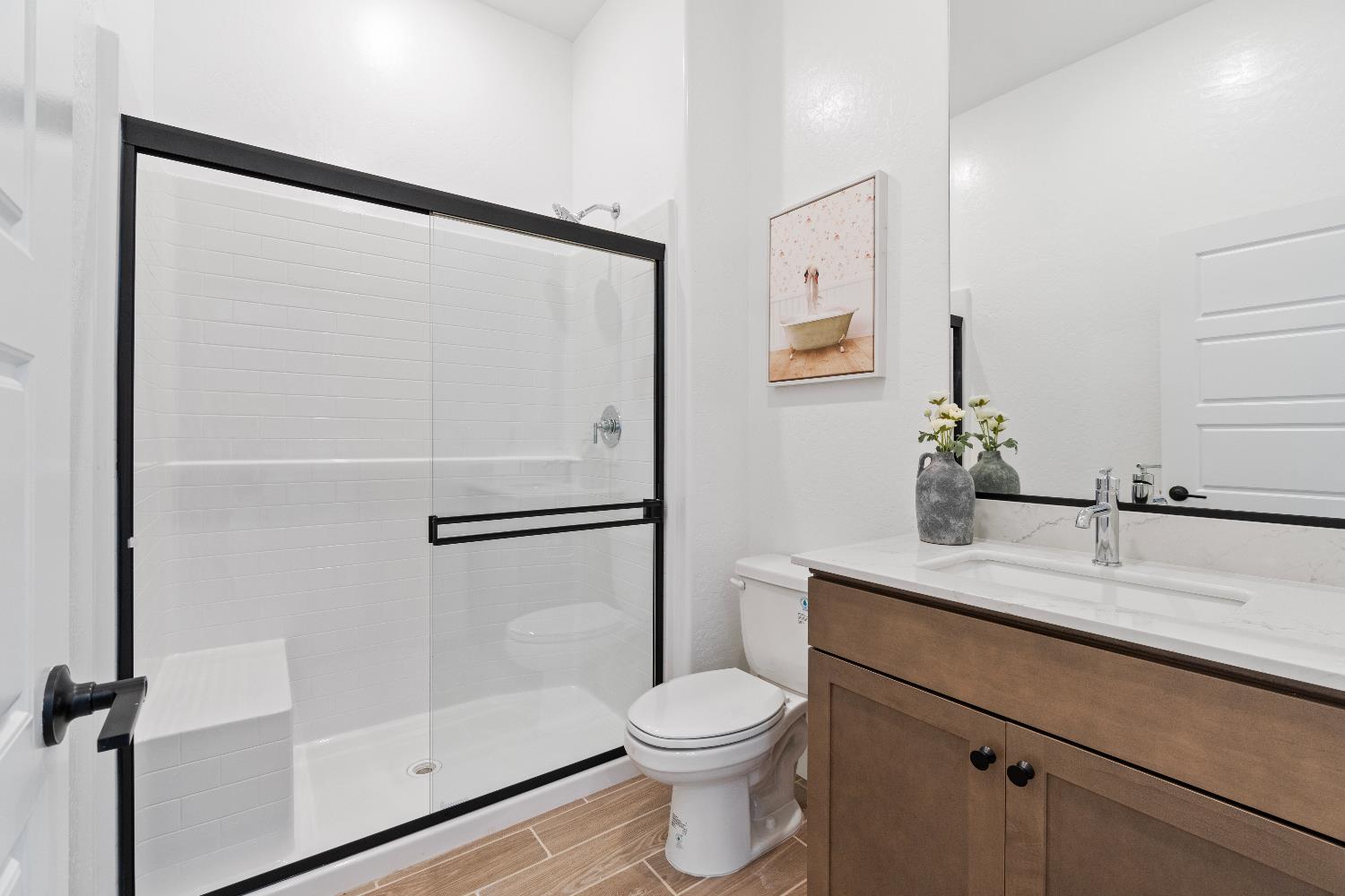 846 Traverse Drive Madera, CA 93636 - Photo 9 of 28 a bathroom with a shower sink vanity and toilet
