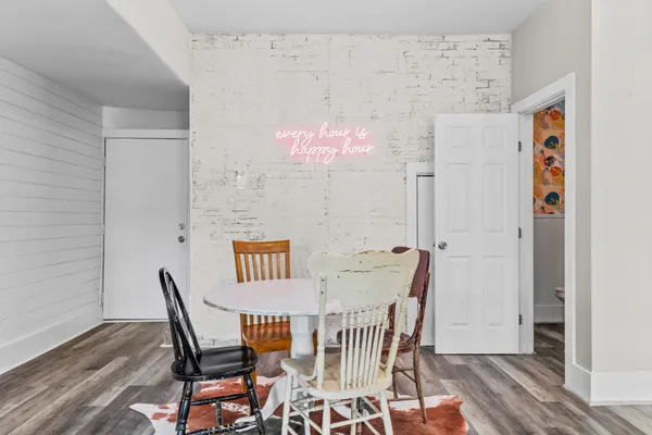 a view of a dining room with furniture and wooden floor