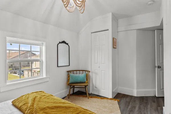 a bedroom with a bed and a window