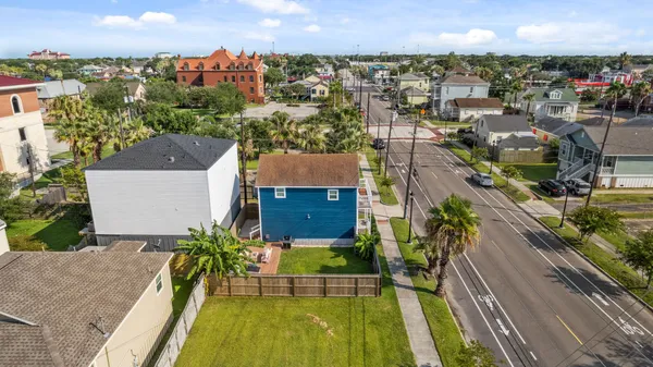 an aerial view of a house with a swimming pool and outdoor seating