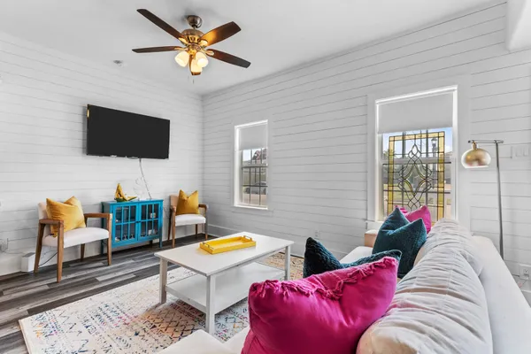 a living room with furniture and a flat screen tv