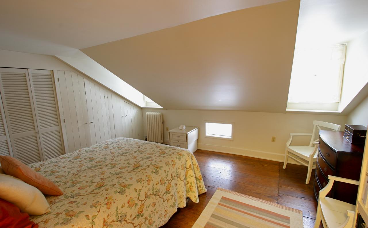 454 Main Road, Unit 8 Monterey, MA 01245 - Photo 11 of 22 a spacious bedroom with a bed and chair