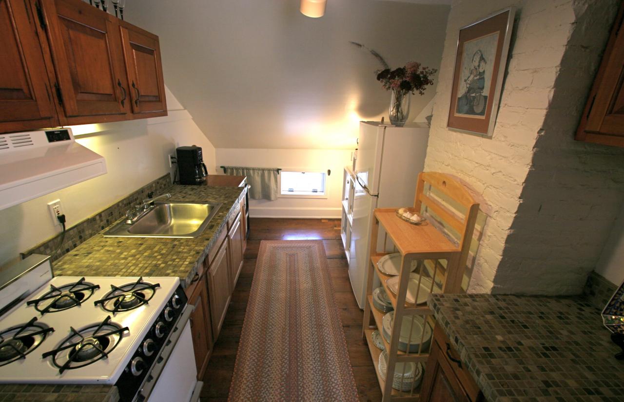 454 Main Road, Unit 8 Monterey, MA 01245 - Photo 15 of 22 a view of a kitchen with chair and wooden floor