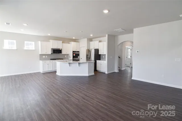 a view of kitchen with stainless steel appliances refrigerator microwave and stove