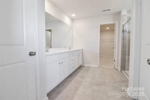 a bathroom with a double vanity sink and mirror
