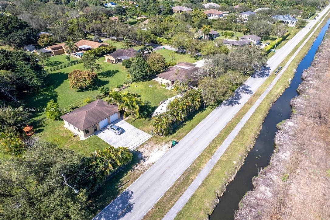 13602 Southwest 24th Street Davie, FL 33325 - Photo 1 of 6 a view of a house with a yard and pool