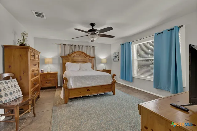 a bedroom with a bed dresser and a window