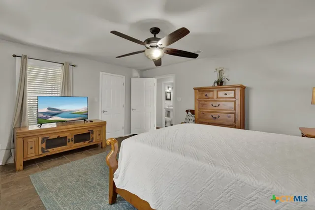 a bedroom with furniture and a flat screen tv