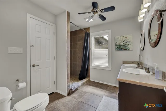 a bathroom with a sink toilet and a mirror