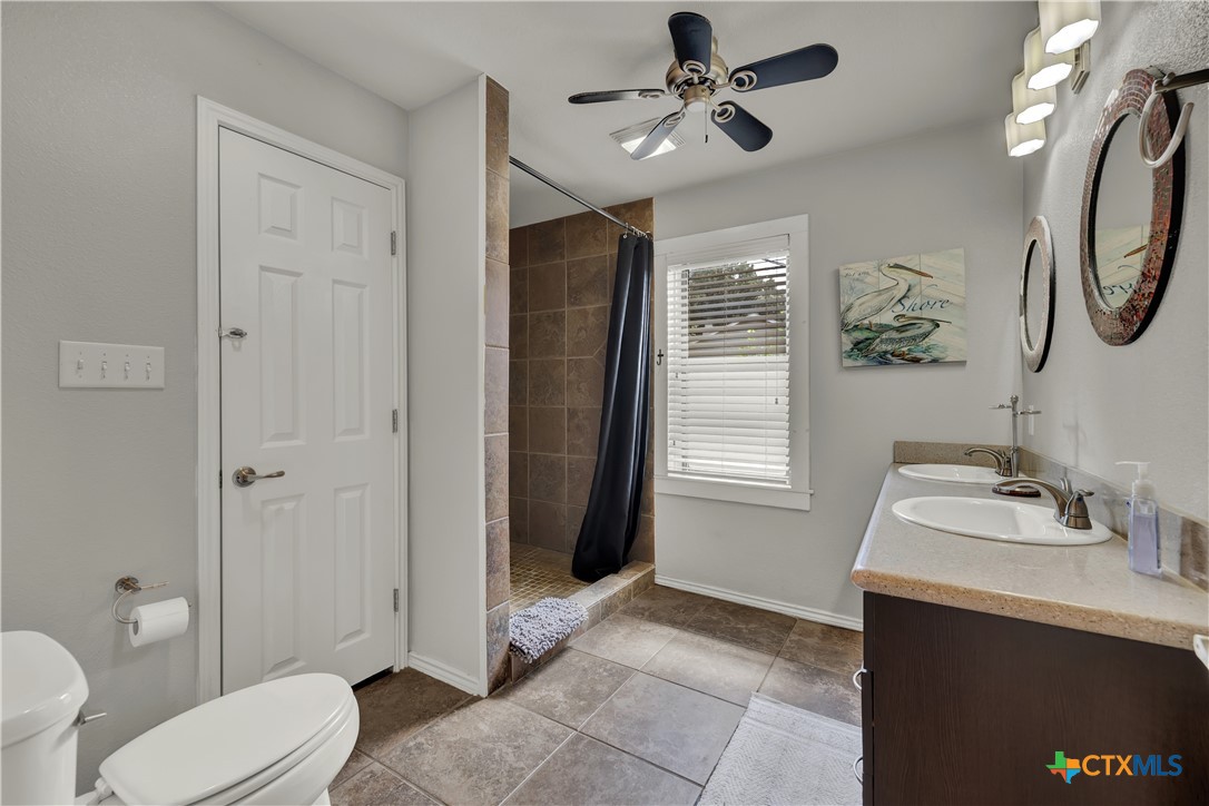 1015 Reiley Road Seguin, TX 78155 - Photo 17 of 41 a bathroom with a sink a toilet and shower