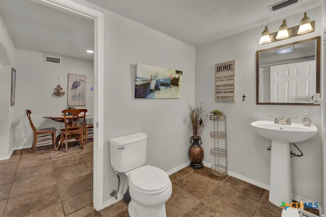 a view of a wooden deck with chairs and a yard