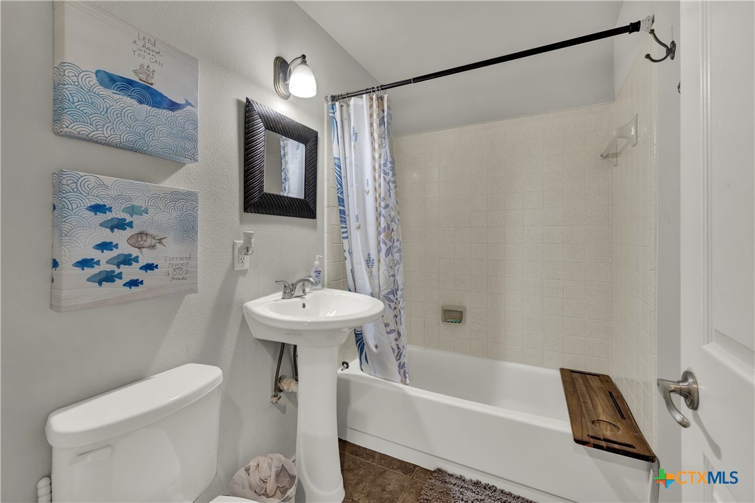 1015 Reiley Road Seguin, TX 78155 - Photo 20 of 41 a bathroom with a sink a toilet and a bathtub