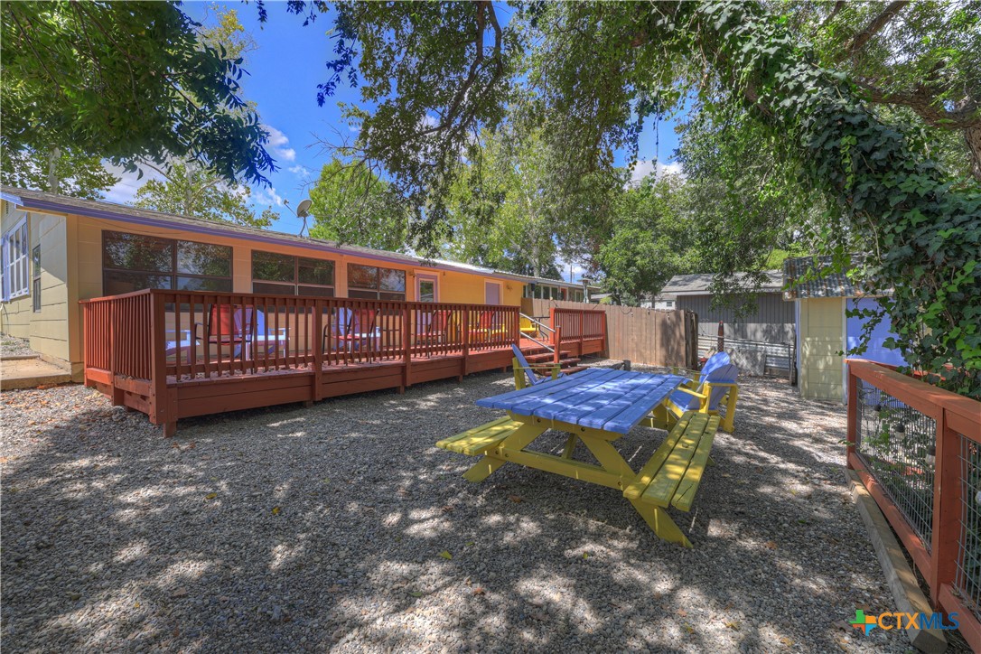 1015 Reiley Road Seguin, TX 78155 - Photo 21 of 41 a view of a wooden deck with chairs and a yard