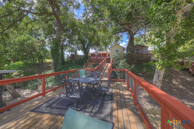 a view of balcony with wooden floor and fence