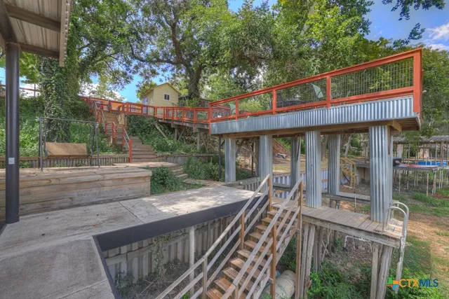 a view of a wooden deck and a backyard