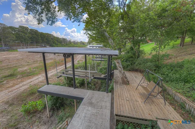 a balcony with lots of green space and plants