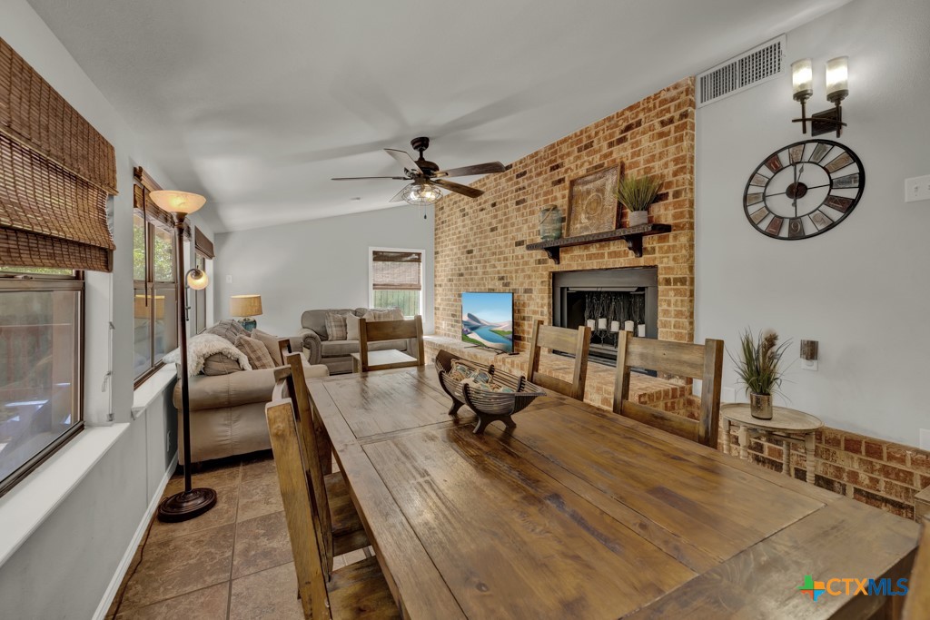1015 Reiley Road Seguin, TX 78155 - Photo 9 of 41 a living room with furniture a fireplace and a chandelier