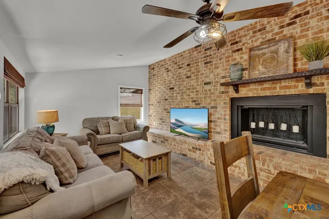 a living room with furniture and a fireplace