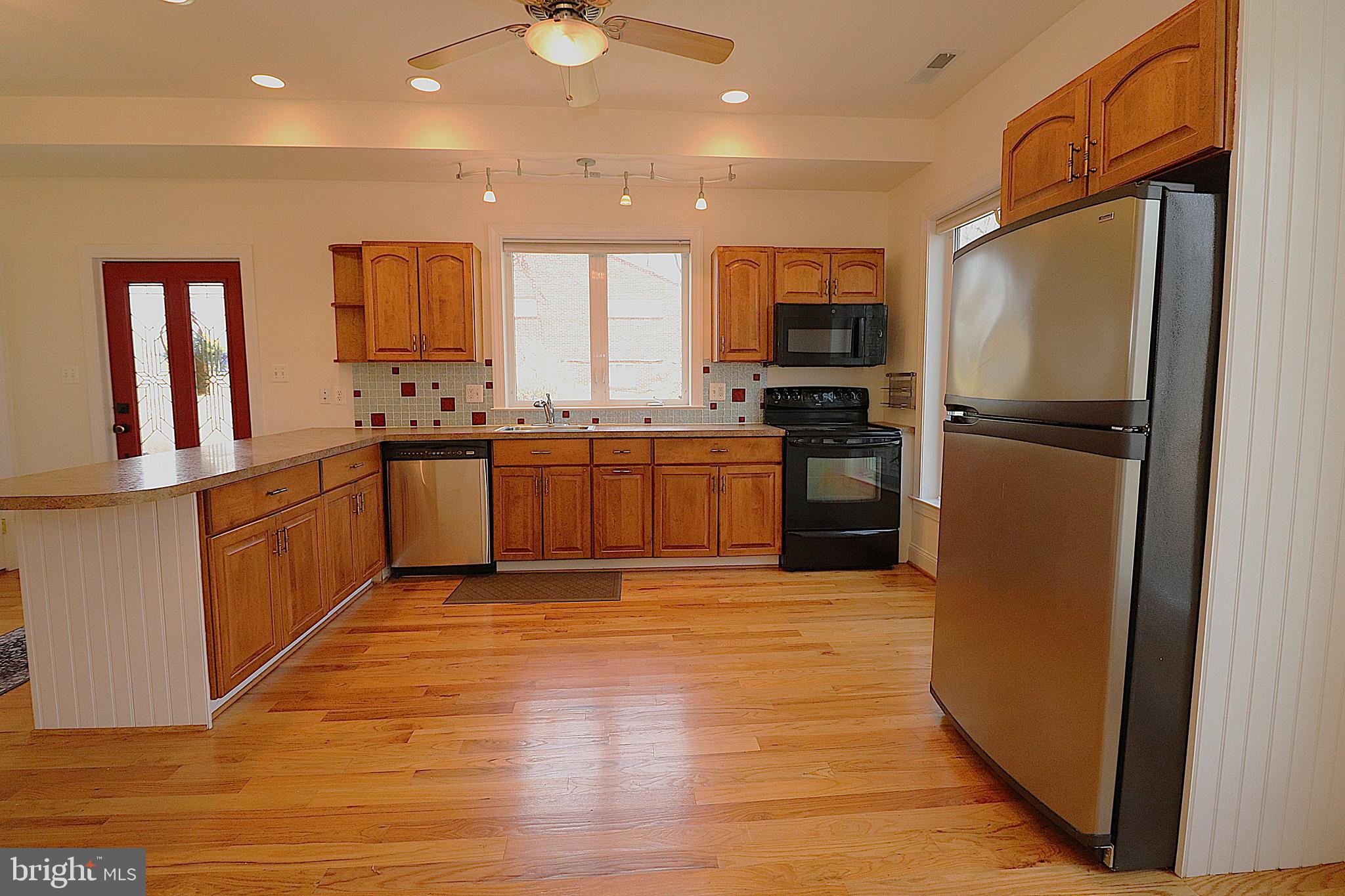 118 Quaint Acres Drive Silver Spring, MD 20904 - Photo 12 of 41 a kitchen with stainless steel appliances granite countertop a refrigerator a stove top oven a sink and dishwasher