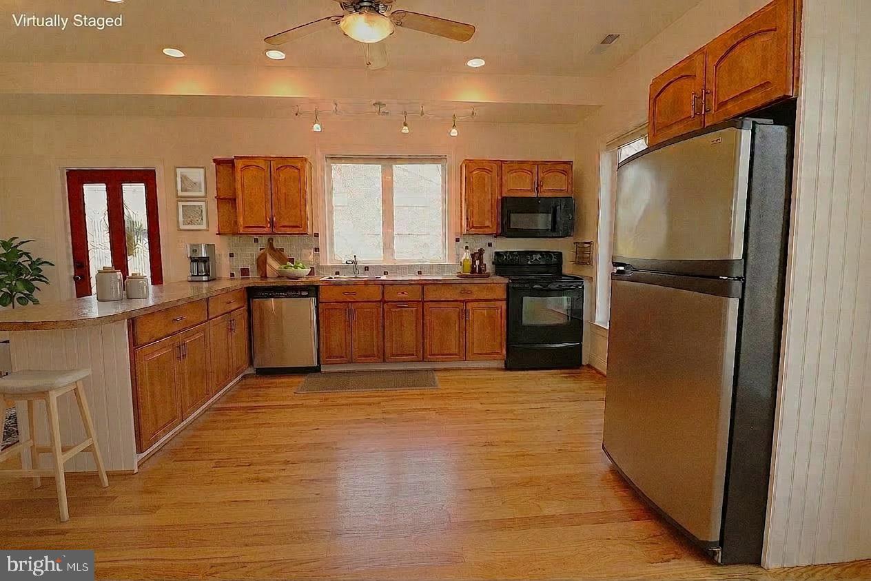 118 Quaint Acres Drive Silver Spring, MD 20904 - Photo 13 of 41 a large kitchen with stainless steel appliances granite countertop a stove top oven a sink and a refrigerator
