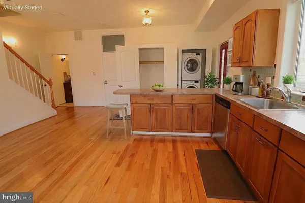 a view of a room with wooden floor and a ceiling fan