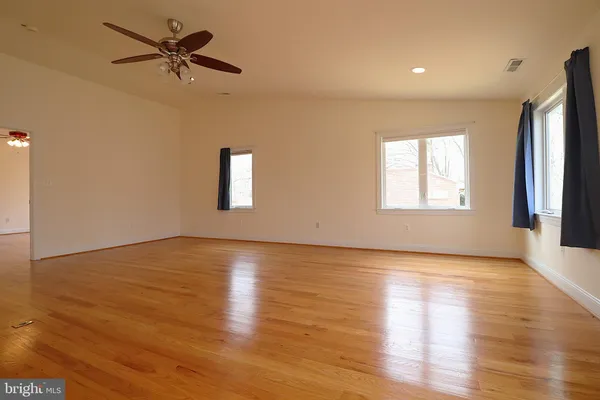 a view of an empty room with wooden floor