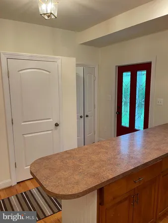 a view of front door with a red door and a window