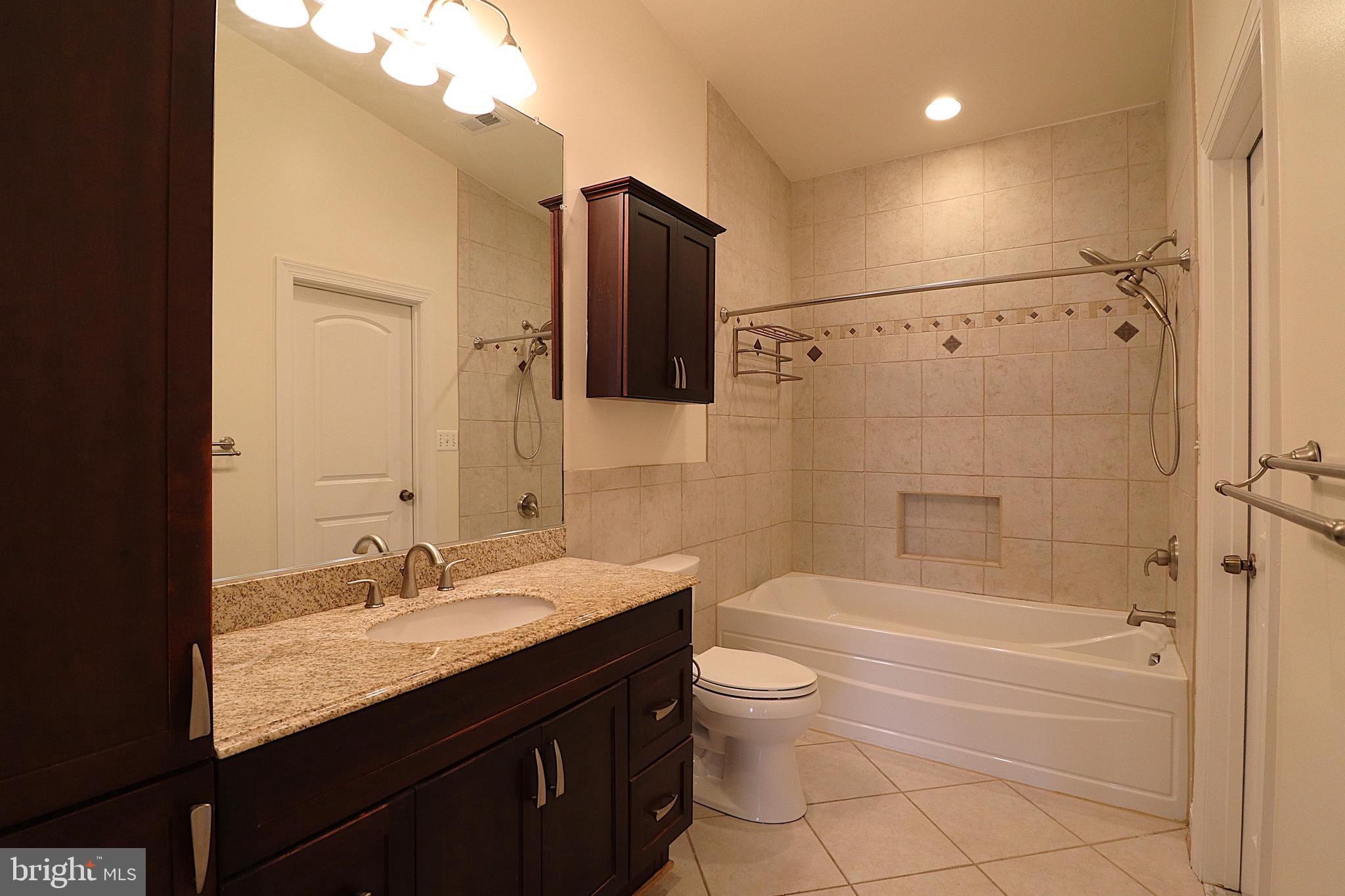 118 Quaint Acres Drive Silver Spring, MD 20904 - Photo 25 of 41 a bathroom with a granite countertop sink toilet and shower
