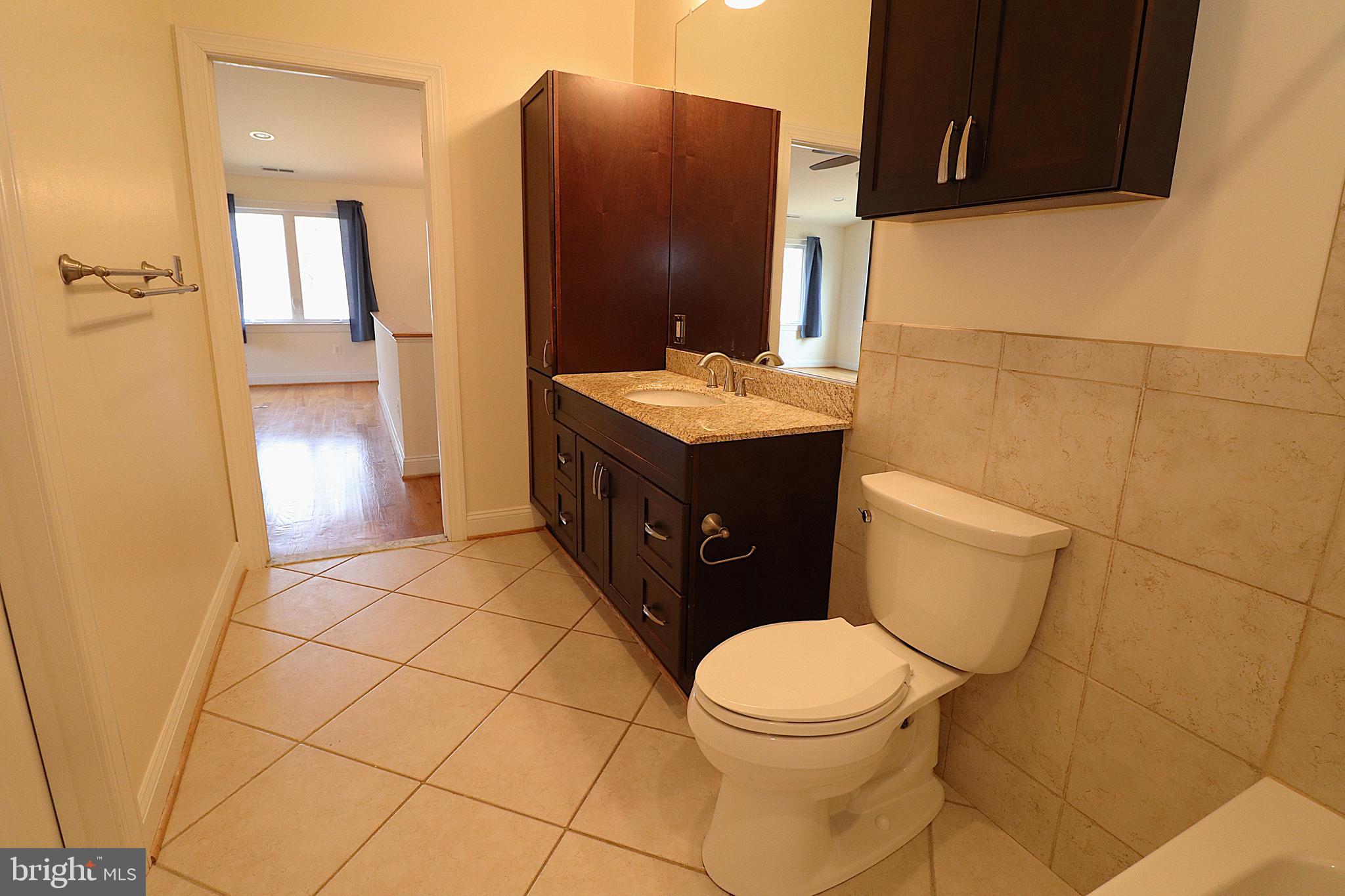 118 Quaint Acres Drive Silver Spring, MD 20904 - Photo 26 of 41 a bathroom with a granite countertop toilet and a sink