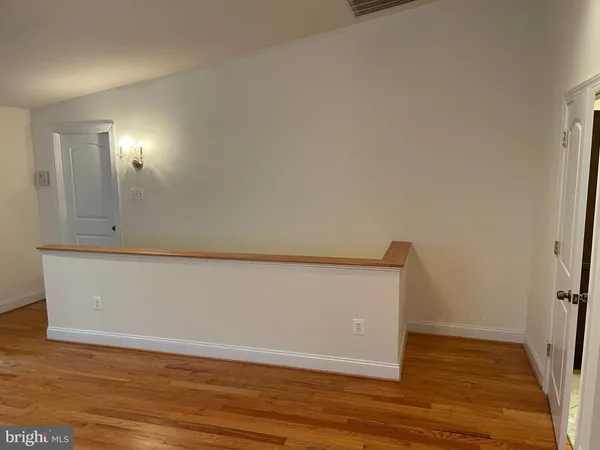a view of a room with wooden floor