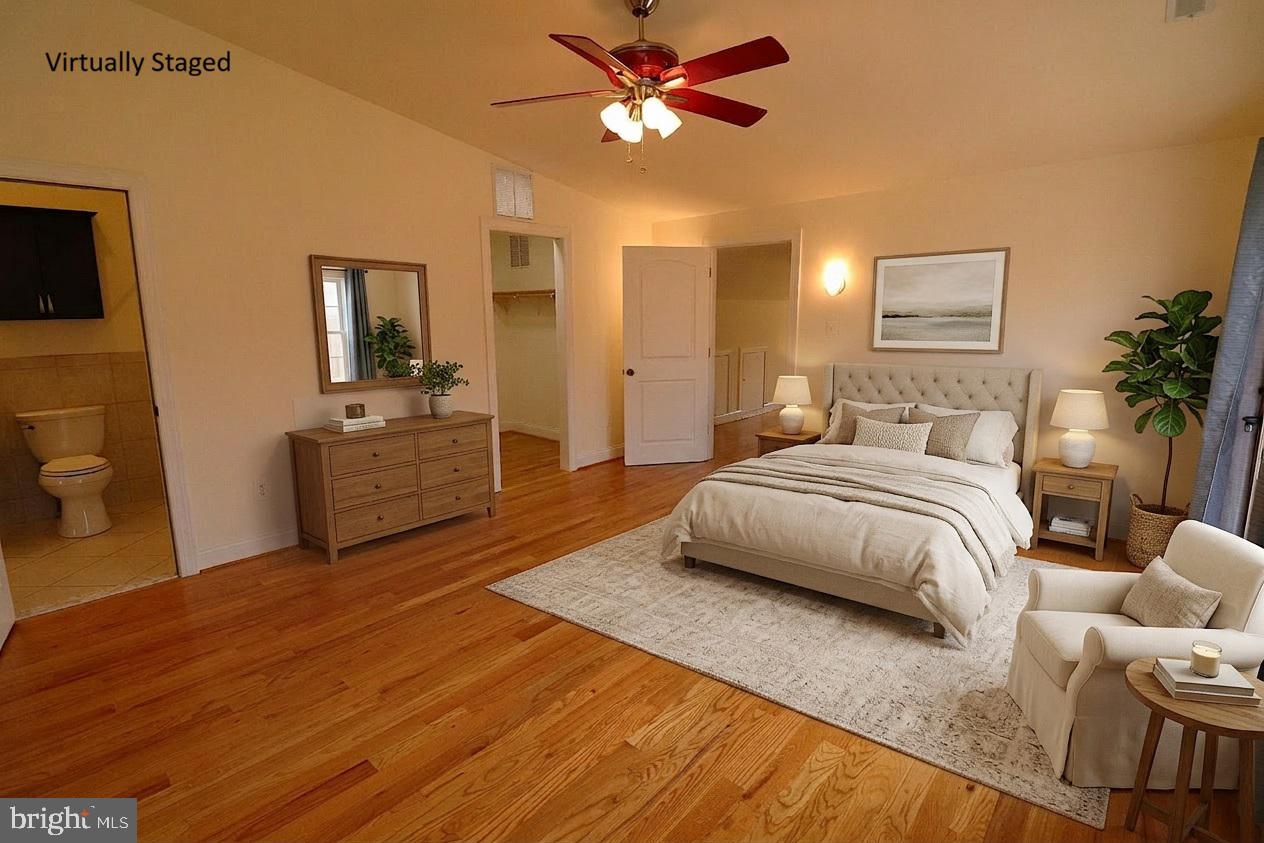118 Quaint Acres Drive Silver Spring, MD 20904 - Photo 28 of 41 a spacious bedroom with a bed and a chandelier