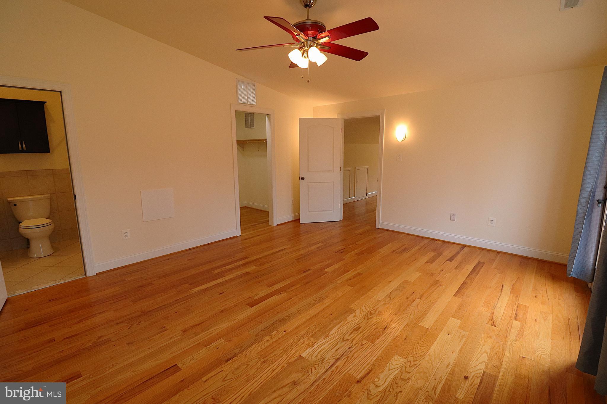 118 Quaint Acres Drive Silver Spring, MD 20904 - Photo 29 of 41 a view of a room with wooden floor and a ceiling fan