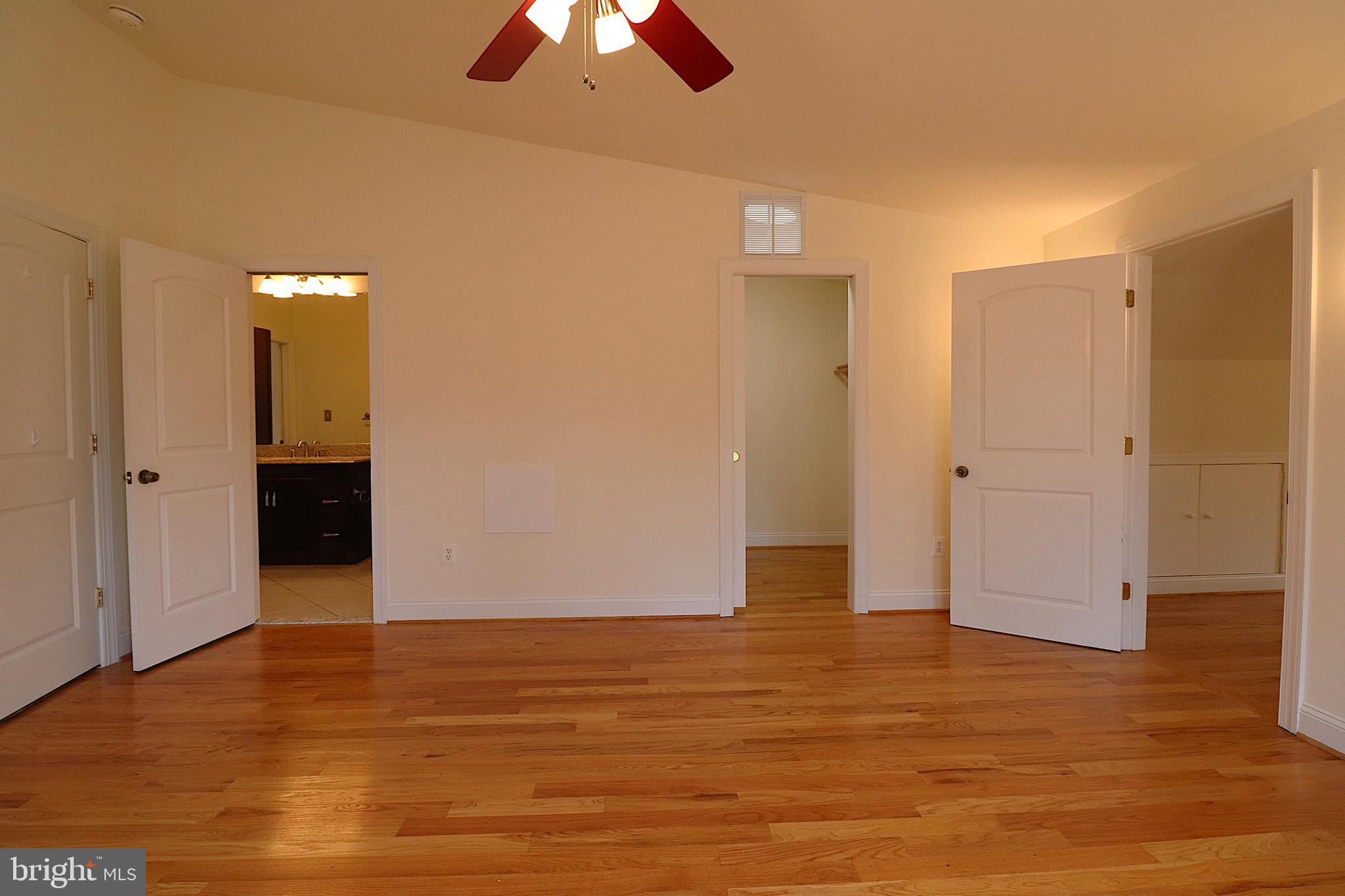 118 Quaint Acres Drive Silver Spring, MD 20904 - Photo 30 of 41 an empty room with wooden floor and chandelier fan