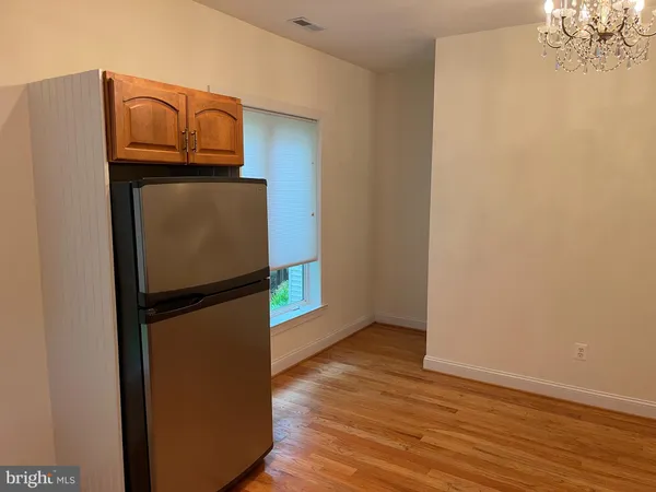 a view of a kitchen with a refrigerator a microwave and a ceiling fan
