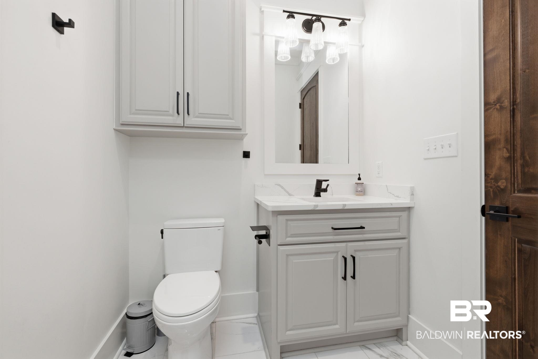 9501 Ben Hamilton Road Theodore, AL 36582 - Photo 37 of 69 Half bathroom with vanity and light marble finish floors