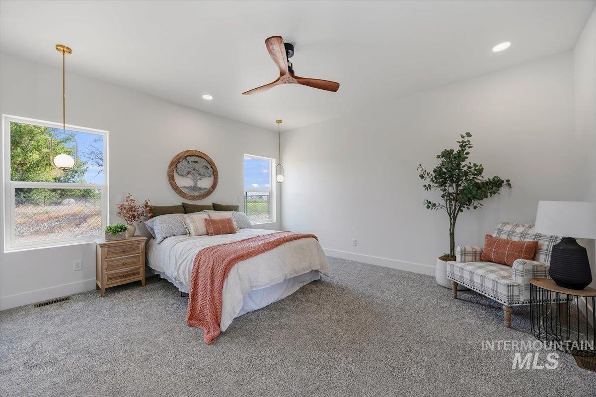2005 Sparrow Street Rupert, ID 83350 - Photo 15 of 30 Spacious room featuring vaulted ceilings, light gray carpet flooring, recessed lighting, and a modern wood-finish ceiling fan