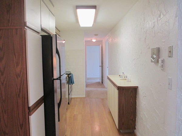 140 Swanson Road, Unit 424 Boxborough, MA 01719 - Photo 7 of 18 a view of hallway with stainless steel appliances a refrigerator and a window