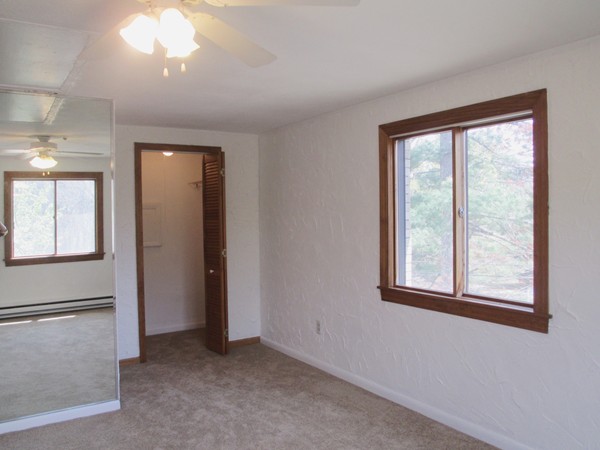 140 Swanson Road, Unit 424 Boxborough, MA 01719 - Photo 9 of 18 an empty room with windows and closet