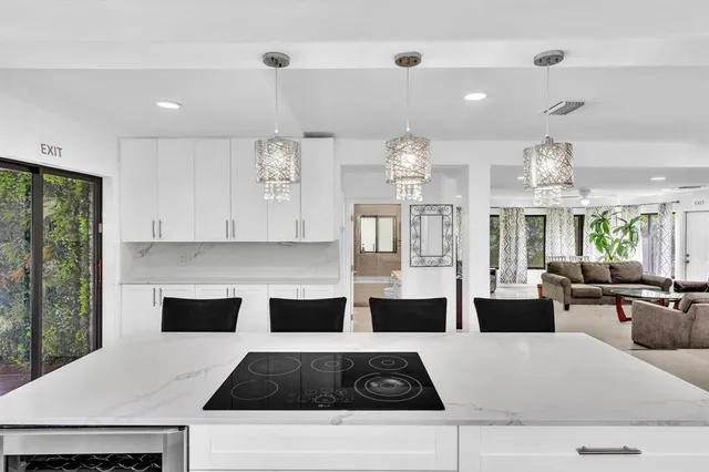 a kitchen with a stove and white cabinets