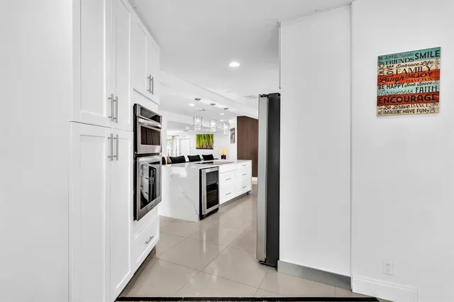 a kitchen with stainless steel appliances a refrigerator a stove top oven