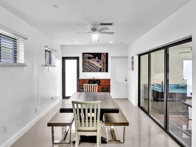 a view of a dining room with furniture a chandelier and wooden floor