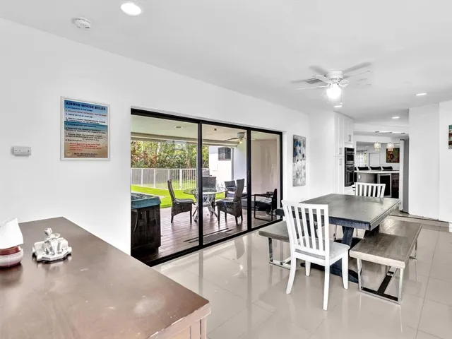 a dining room with furniture a chandelier and living room view